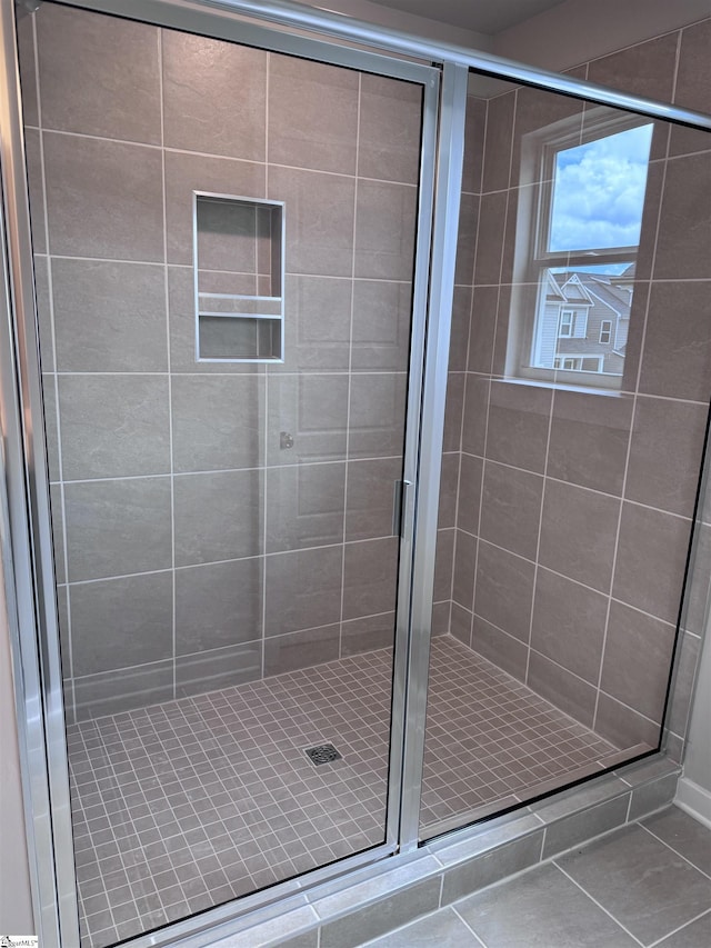 bathroom with tile patterned floors and walk in shower