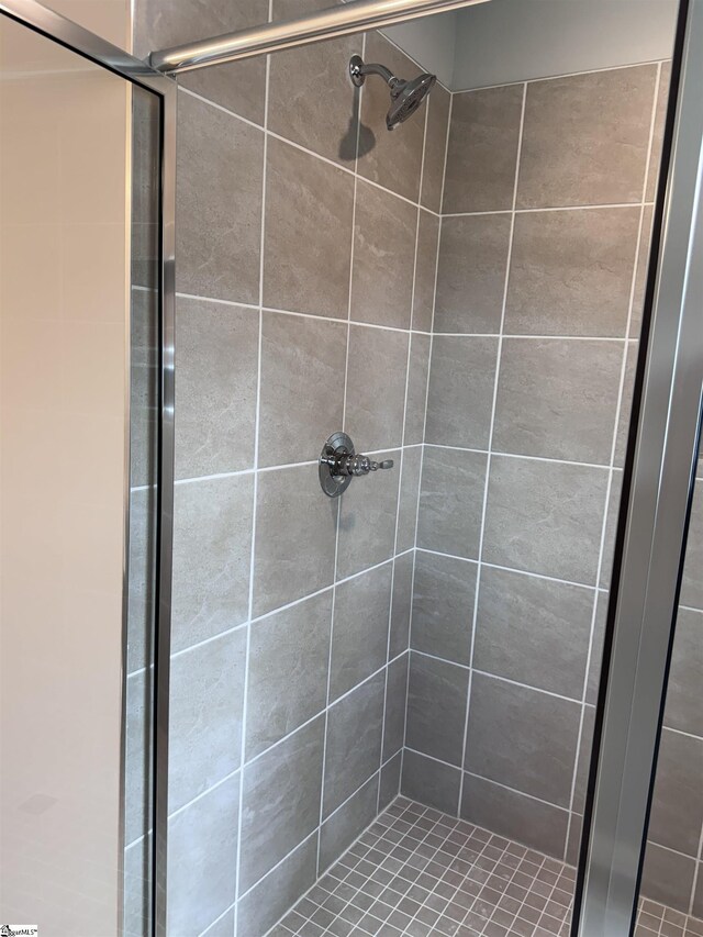 bathroom with tiled shower