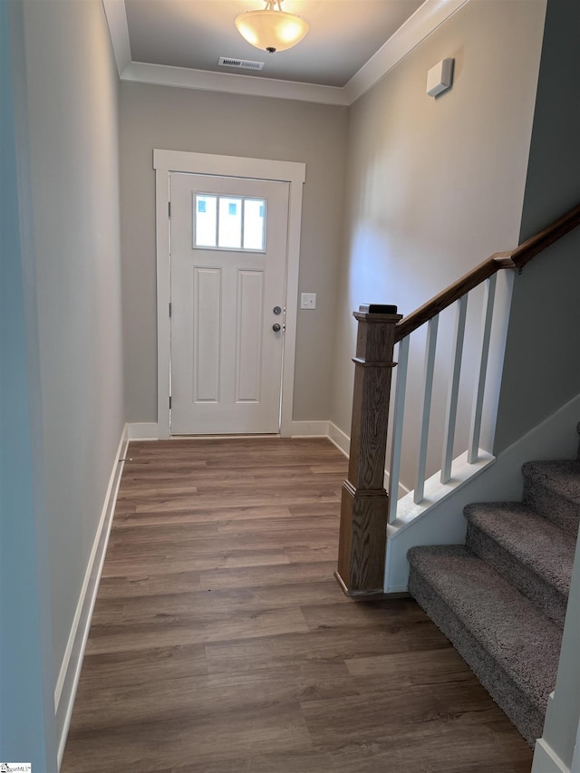 entrance foyer featuring wood-type flooring and ornamental molding