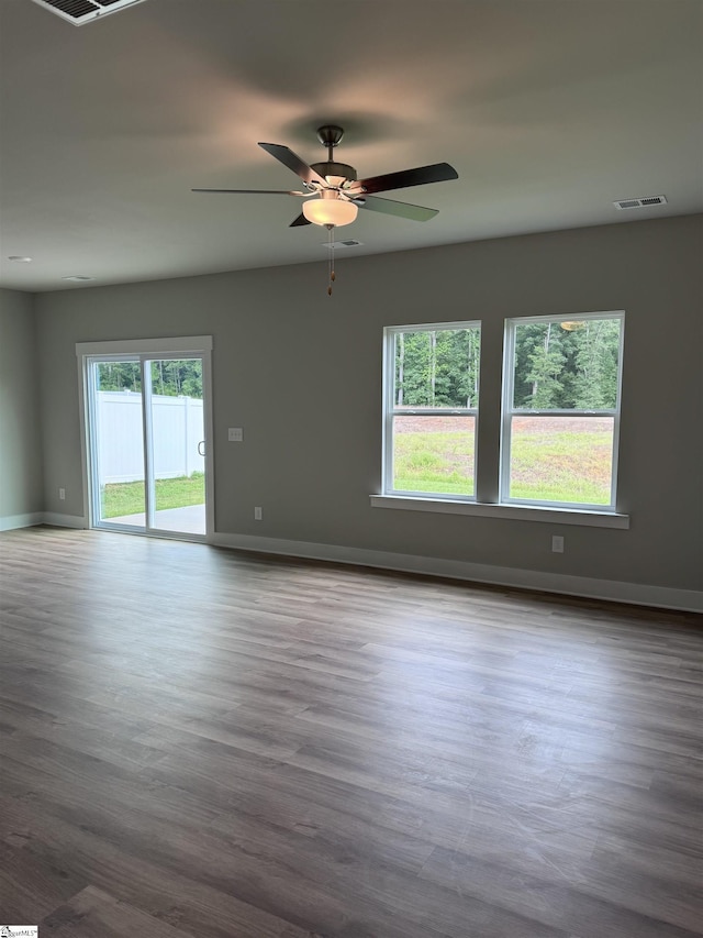 unfurnished room with ceiling fan, plenty of natural light, and light hardwood / wood-style floors