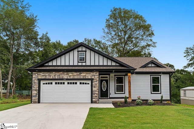 view of front facade featuring an attached garage, board and batten siding, a front yard, stone siding, and driveway