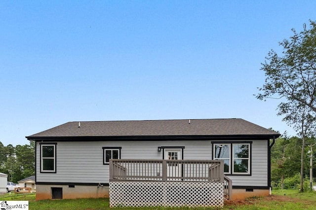 rear view of property featuring a deck, roof with shingles, and crawl space