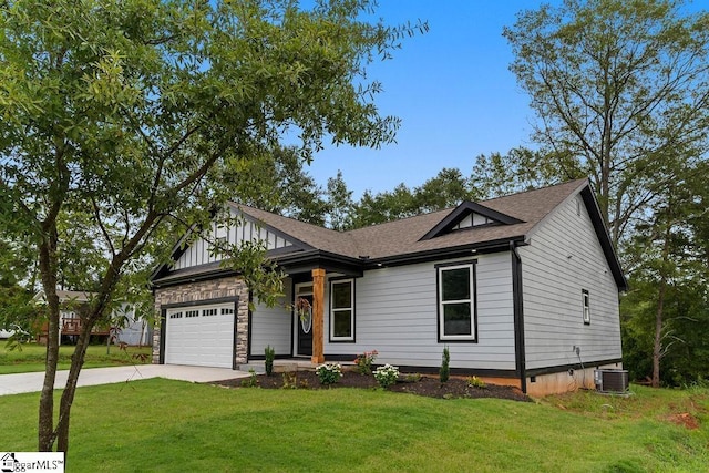 view of front of house featuring a shingled roof, concrete driveway, central AC, a garage, and a front lawn