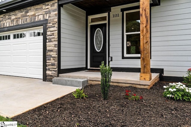 entrance to property with a porch and stone siding