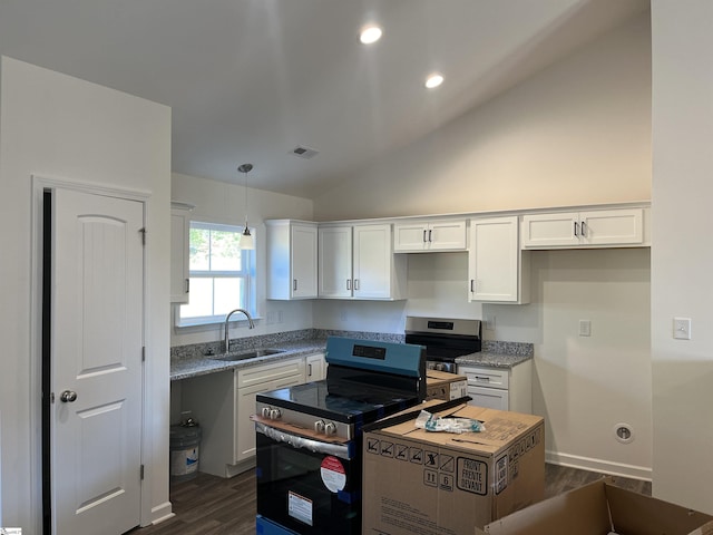 kitchen with lofted ceiling, stainless steel range with electric cooktop, sink, light stone countertops, and white cabinetry