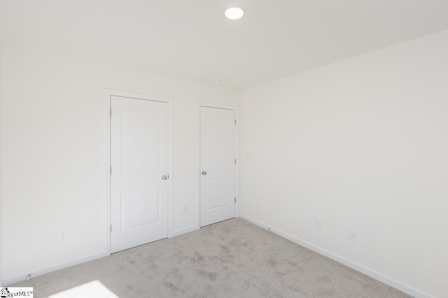 unfurnished bedroom featuring light colored carpet