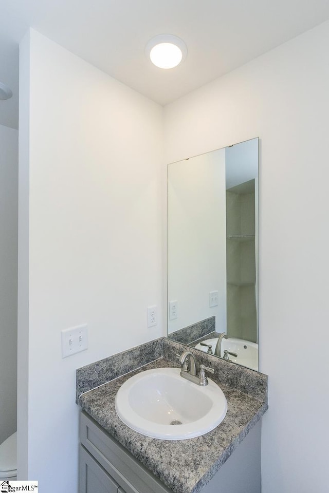 bathroom featuring vanity and toilet