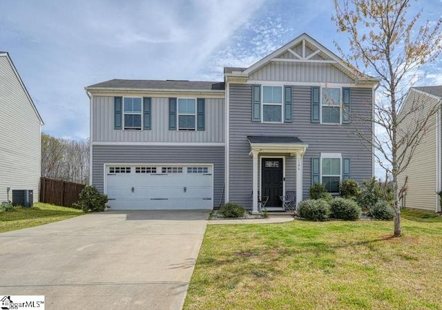 view of front of home with a front lawn, central AC unit, and a garage