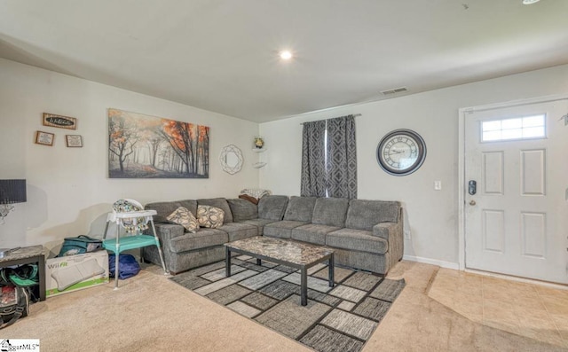 tiled living room featuring carpet, baseboards, and visible vents