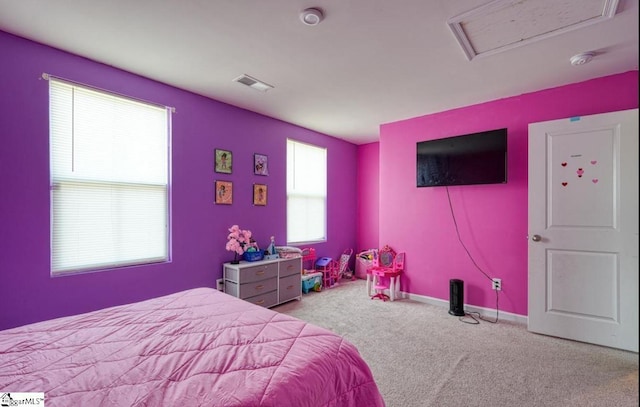 carpeted bedroom featuring baseboards, attic access, and visible vents