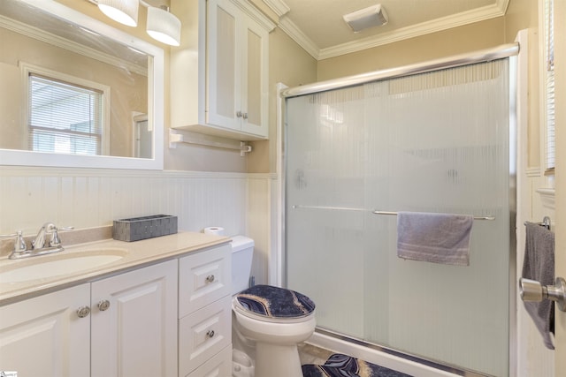 bathroom with walk in shower, ornamental molding, toilet, and vanity