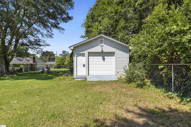 view of outbuilding with a garage and a lawn