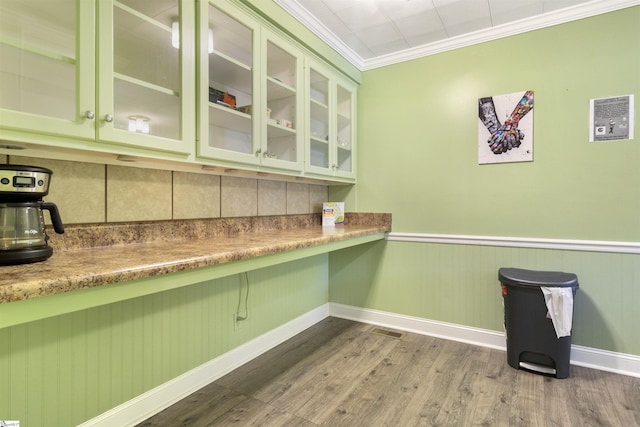 interior space featuring hardwood / wood-style flooring and crown molding