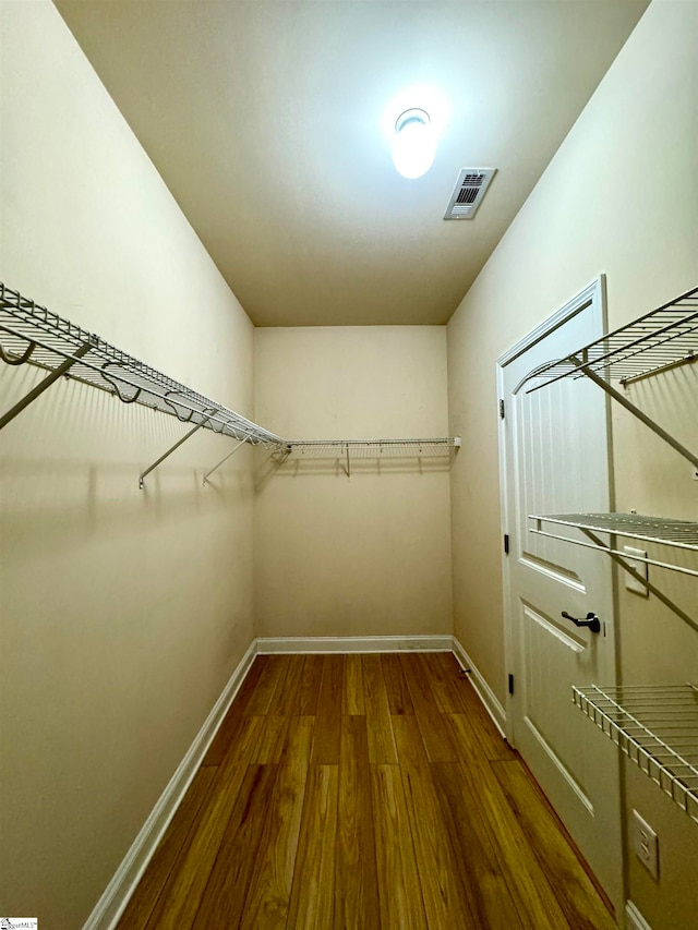 walk in closet featuring dark hardwood / wood-style flooring