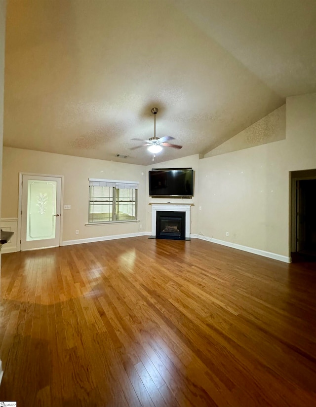 unfurnished living room featuring ceiling fan, hardwood / wood-style flooring, and vaulted ceiling