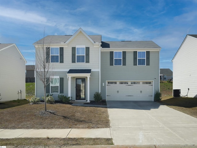 view of front of home with a garage and central AC unit