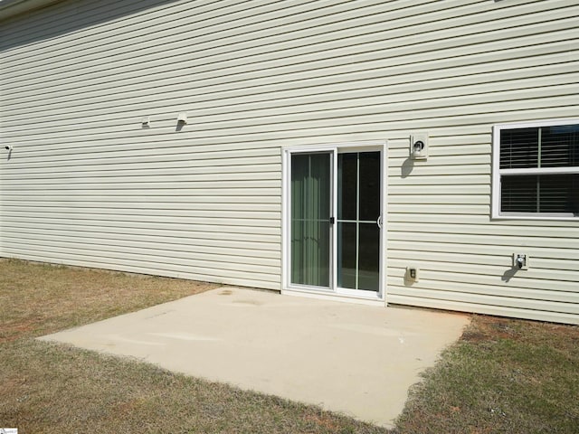 entrance to property with a patio area