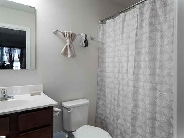 bathroom featuring vanity and toilet