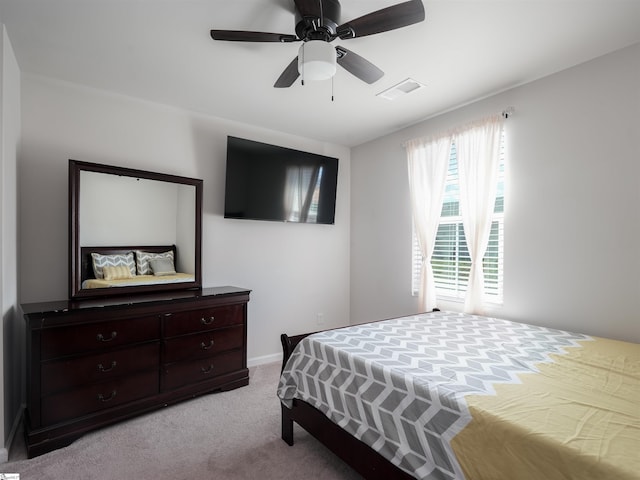 bedroom with light carpet and ceiling fan