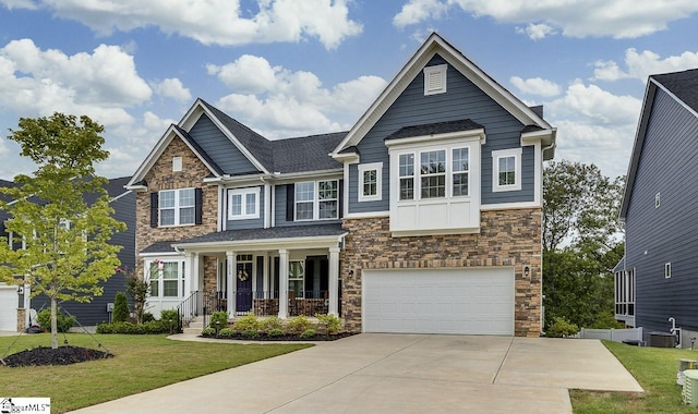 craftsman inspired home with a porch, a garage, and a front yard