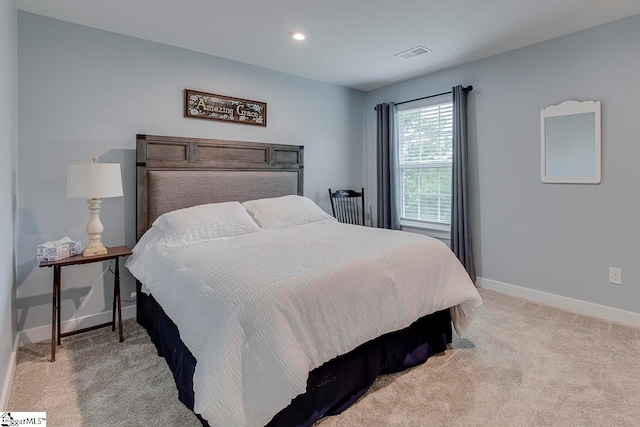 bedroom featuring light colored carpet