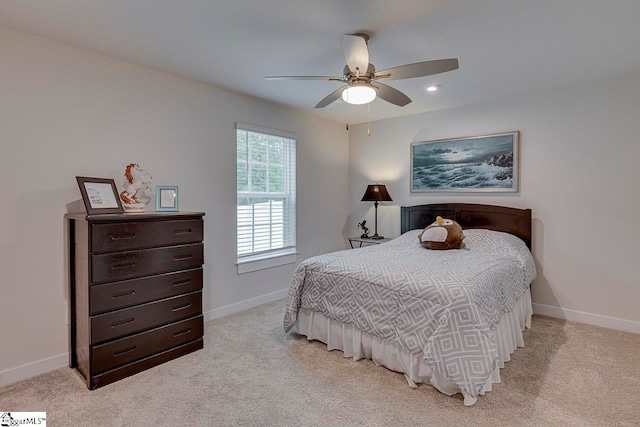 bedroom featuring light carpet and ceiling fan