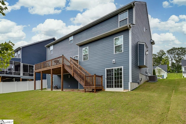 back of property featuring a deck, central AC, a sunroom, and a yard