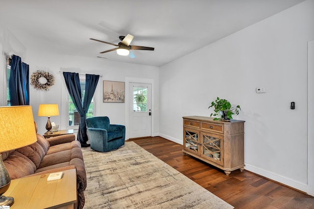 living room with dark hardwood / wood-style floors and ceiling fan