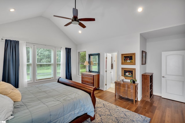 bedroom with wood-type flooring, multiple windows, ensuite bathroom, and ceiling fan