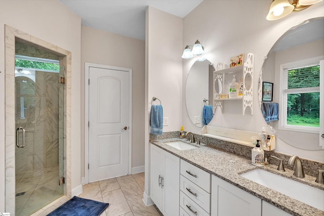 bathroom with a shower with shower door, tile patterned flooring, and dual bowl vanity