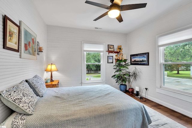 bedroom with ceiling fan and dark wood-type flooring