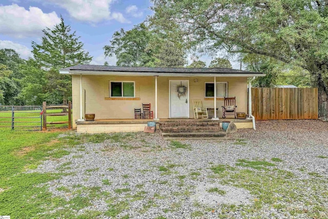 view of front of home with a porch and a front lawn