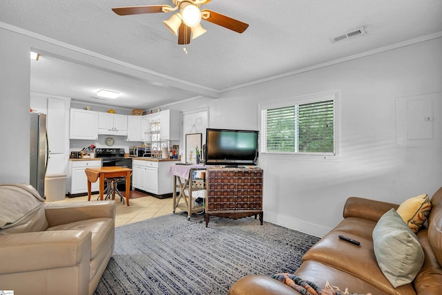 tiled living room featuring a textured ceiling and ceiling fan