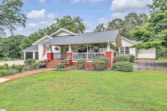 view of front of property with a garage, a porch, and a front yard