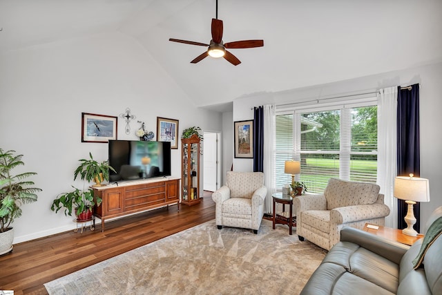 living room with hardwood / wood-style flooring, high vaulted ceiling, and ceiling fan