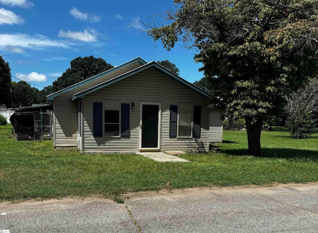 bungalow-style home with a front yard