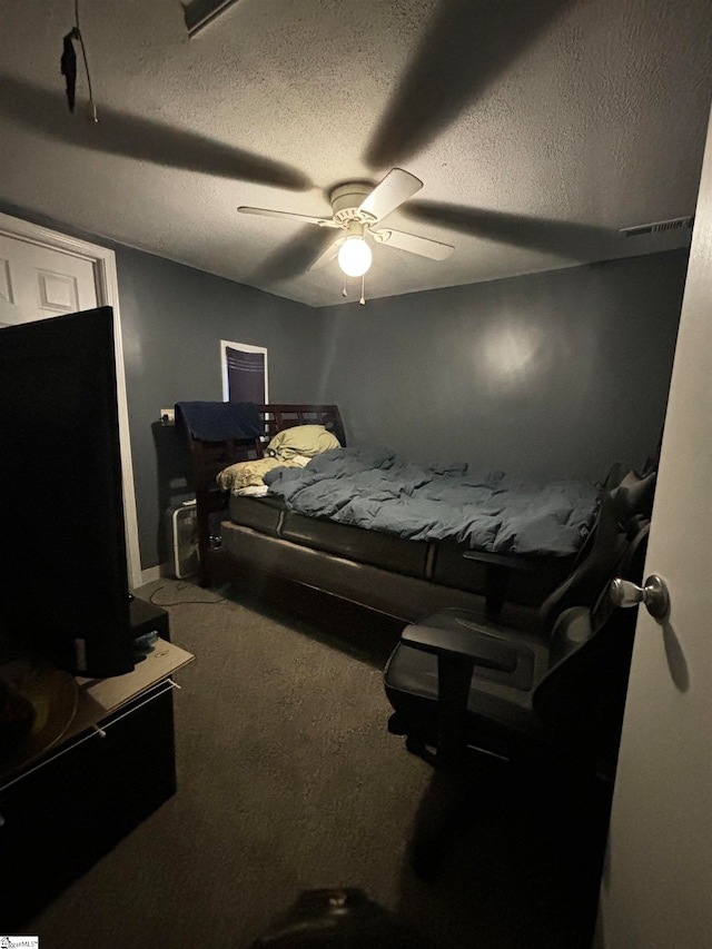 bedroom featuring carpet floors, a textured ceiling, and ceiling fan