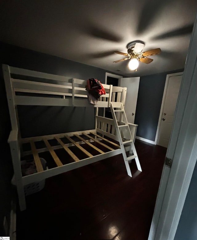 unfurnished bedroom featuring hardwood / wood-style flooring and ceiling fan