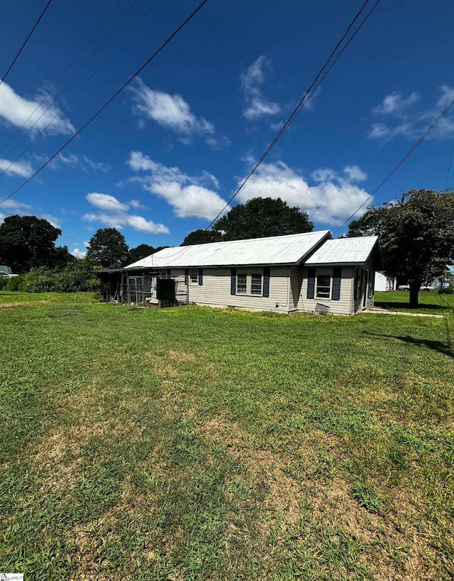 rear view of property featuring a yard