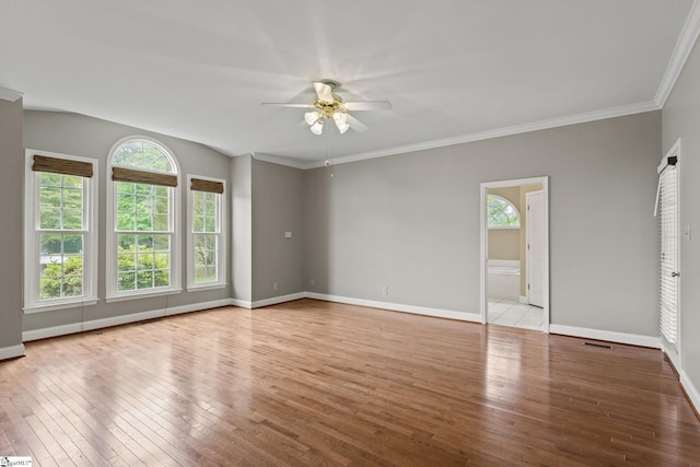 empty room featuring hardwood / wood-style floors, crown molding, and ceiling fan