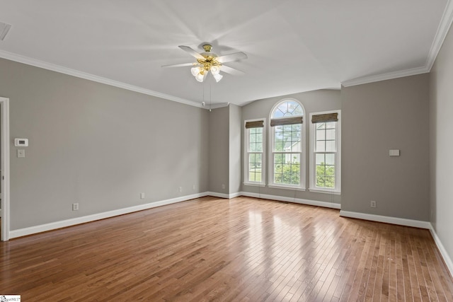 empty room featuring ceiling fan, ornamental molding, and wood-type flooring