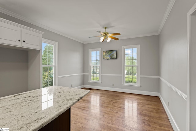 interior space with light hardwood / wood-style flooring, crown molding, and ceiling fan