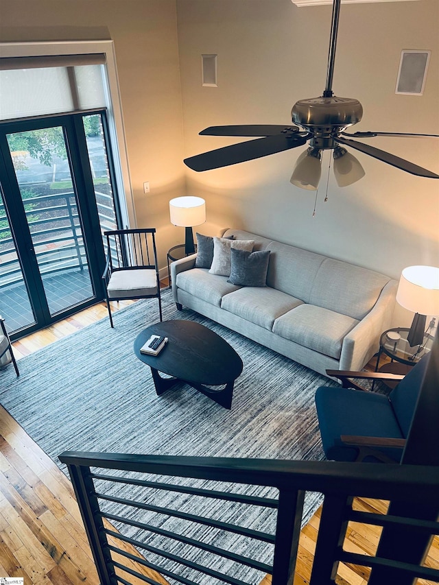 living room featuring ceiling fan and light hardwood / wood-style flooring