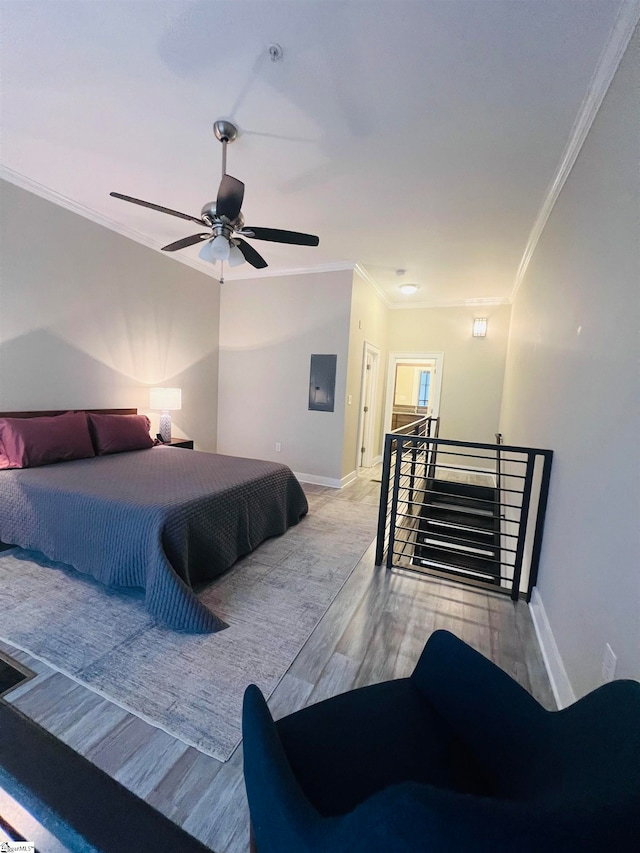 bedroom featuring ceiling fan, light wood-type flooring, and ornamental molding