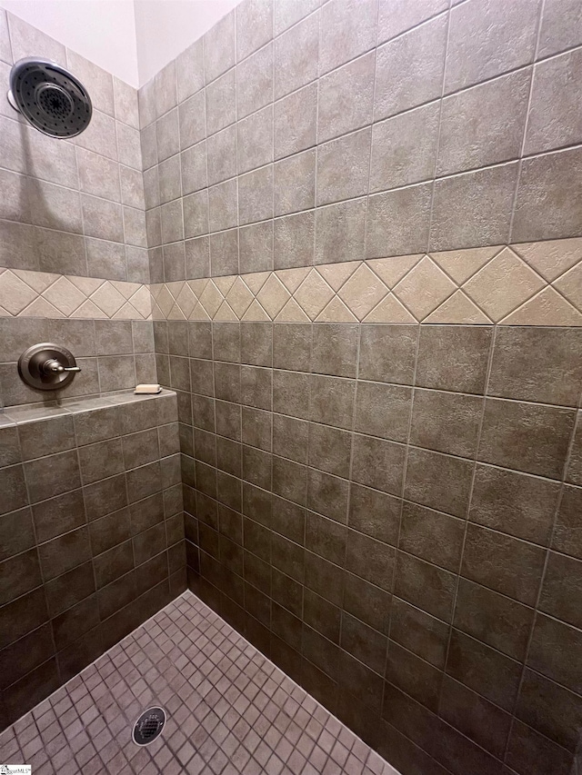 bathroom with a tile shower