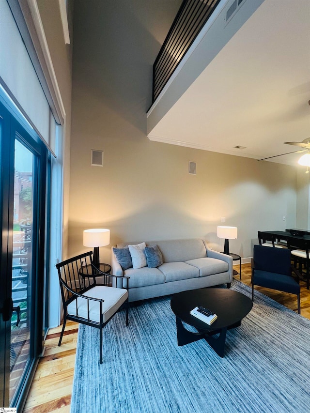 living room featuring ceiling fan and light hardwood / wood-style flooring