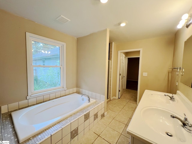 bathroom with a bath, visible vents, tile patterned floors, and a sink