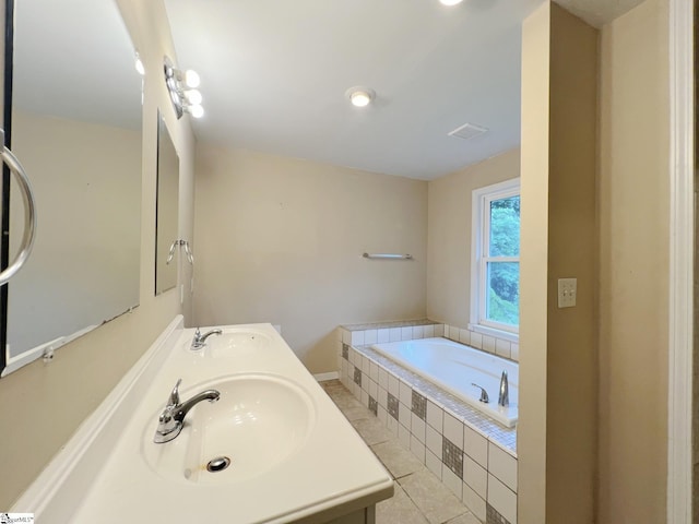 full bathroom with a bath, visible vents, double vanity, and a sink