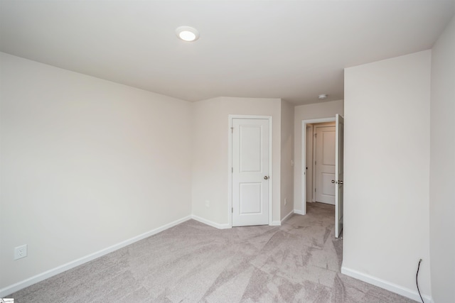 unfurnished bedroom featuring light colored carpet