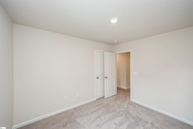 empty room featuring light colored carpet